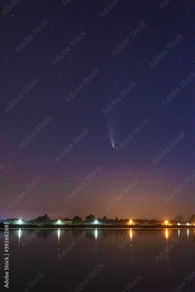 Wall mural a magical starry night on the river by the milky way and a comet in the sky