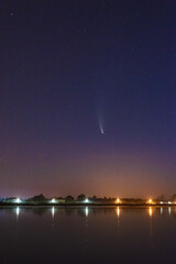 A magical starry night on the river by the Milky Way and a comet in the sky
