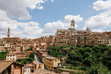 Obraz na płótnie Canvas Panoramic view of Siena city with historic buildings and street