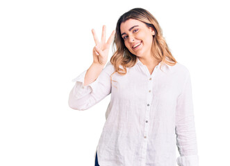 Young caucasian woman wearing casual clothes showing and pointing up with fingers number three while smiling confident and happy.