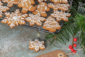 Bright Christmas or New Year wooden background with fir branches, Christmas decorations, Christmas gingerbread cookies, Christmas sweets.