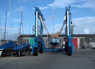 A yacht lying in the slings of a boat crane