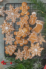 Bright Christmas or New Year wooden background with fir branches, Christmas decorations, Christmas gingerbread cookies, Christmas sweets.