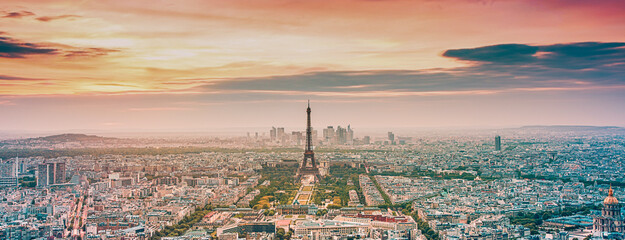 aerial view over Paris at sunset with iconic Eiffel tower
