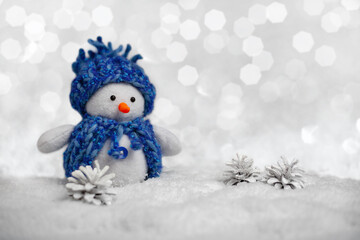Christmas or new year card. handmade snowman on background with bokeh