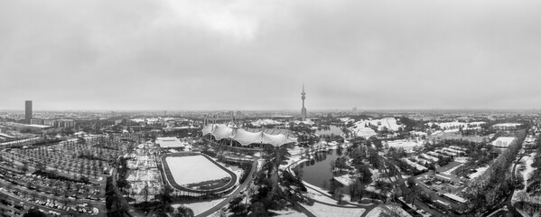 Snowy city of the popular tourism city of Munich in January, an aerial overview at wintertime in black and white.