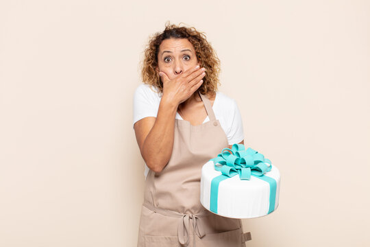 hispanic middle age woman covering mouth with hands with a shocked, surprised expression, keeping a secret or saying oops