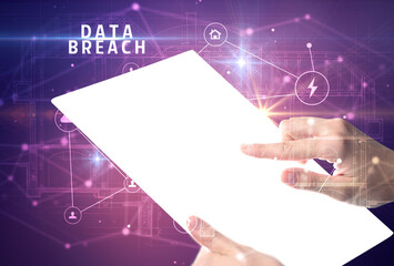 Holding futuristic tablet with DATA BREACH inscription, cyber security concept