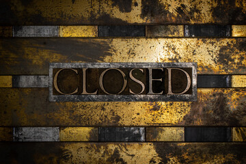 Closed text formed with real authentic typeset letters on vintage textured silver grunge copper and gold background