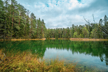 Fototapeta na wymiar Beautiful blue lake in woods. autumn landscape. 