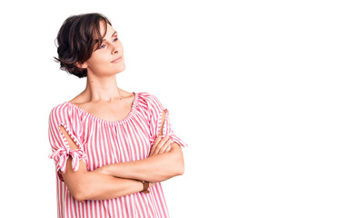 Obraz premium Beautiful young woman with short hair wearing casual summer clothes looking to the side with arms crossed convinced and confident
