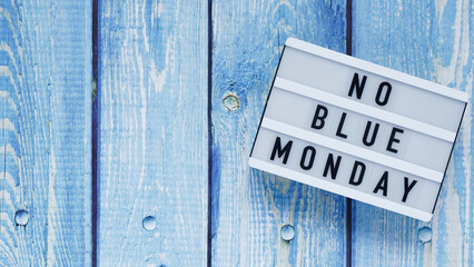 Blue monday day banner concept. White board with text no blue monday on blue wooden background, top...