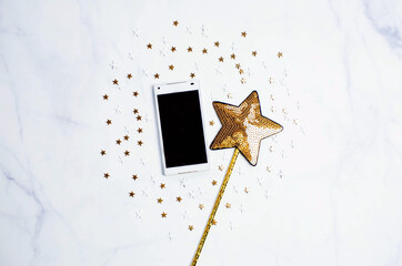 Smartphone with gold sequins in the shape of stars. Mock up template. View from above