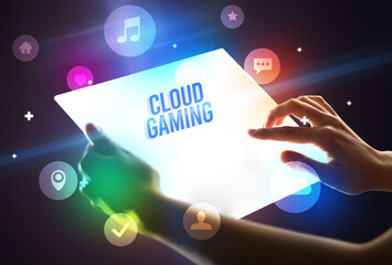 Holding futuristic tablet with CLOUD GAMING inscription, new technology concept