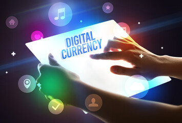 Holding futuristic tablet with DIGITAL CURRENCY inscription, new technology concept