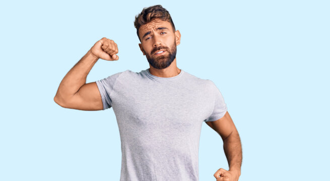 Young hispanic man wearing casual clothes stretching back, tired and relaxed, sleepy and yawning for early morning