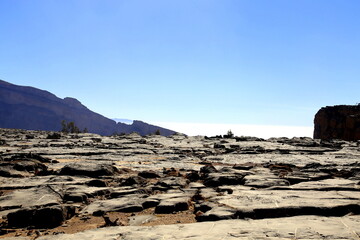View of the mountains against the light, among the polished stones, above the clouds, Jabal Akhdar,...