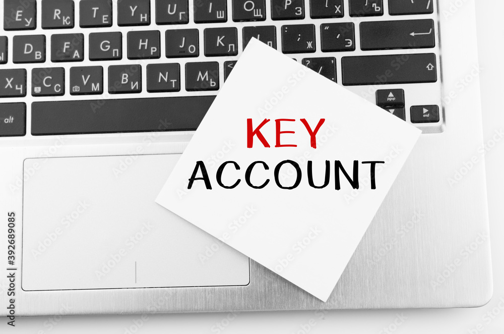 Poster laptop with memo sticks on the keyboard with text key account on it.