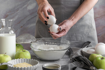 Close up of woman hands preparing sweet pie with apples