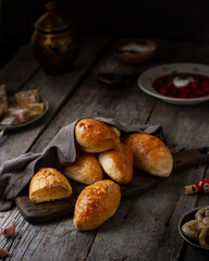 Patties with potatoes on a wooden board on a table made of old boards