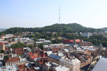 View from the height of the City Hall to the buildings and roofs of Lviv. Ukraine. European architecture. View to the Castle Hill and the TV tower