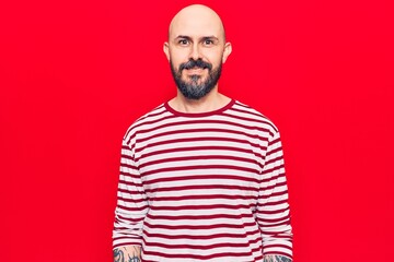 Fototapeta premium Young handsome man wearing casual clothes looking positive and happy standing and smiling with a confident smile showing teeth