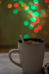 Cup Of Hot Cocoa With Chocolate Wafers, With A Background Of Defocused Christmas Lights.