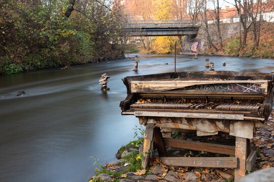 Vilnius, Vilnius / Lithuania - 10192019: Picture of an old piano located on a river bank in Uzupis, Vilnius.