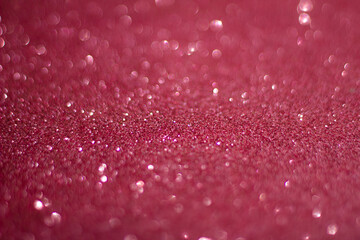 Universal celebration background,  perfect for Christmas or New Year,  cherry color glitter, selective focus
