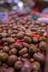Close-up shot of marinated olives with herbs and spices.

