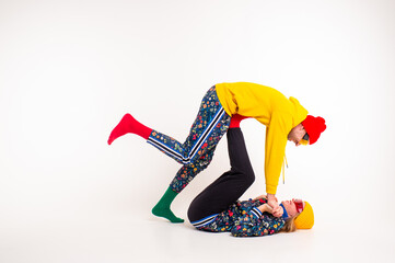 Stylish couple of man and woman in colorful clothes posing  over white background