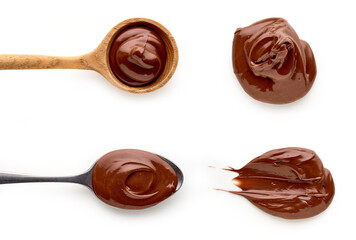 Chocolate cream in spoons isolated on white background, top view