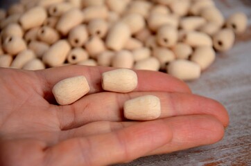 Water drop wood beads in the hand, Group of Unfinished natural wooden beads	