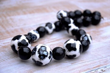 Black and white Beaded Necklace with  Cow pattern on the table