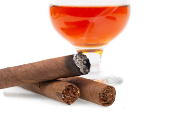 Cuban cigars and glass with cognac isolated on white background