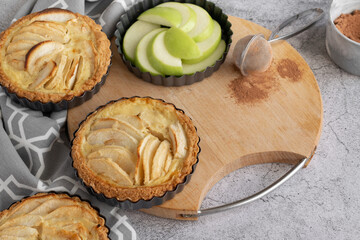 Ready to eat apple pies on grey background
