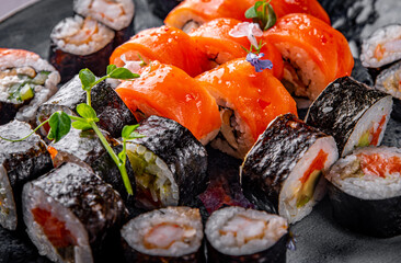 set of sushi roll with salmon, avocado, cream cheese, cucumber, rice, caviar, eel, tuna