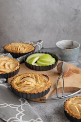 Ready to eat apple pies on grey background