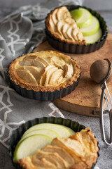 Ready to eat apple pies on grey background