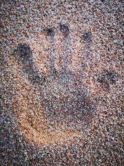 Hand on sand