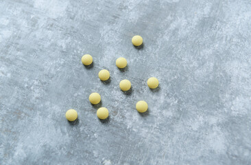 Vitamin C tablets on  wooden background. Close up. Copy space. 