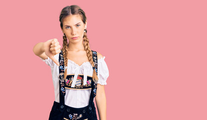 Beautiful caucasian woman with blonde hair wearing octoberfest traditional clothes looking unhappy...
