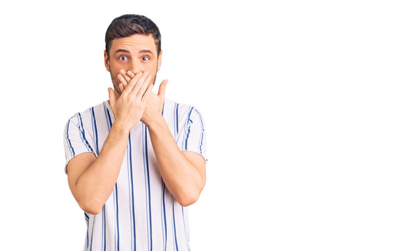 Handsome young man with bear wearing casual clothes shocked covering mouth with hands for mistake. secret concept.