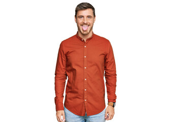 Fototapeta premium Handsome caucasian man wearing casual clothes sticking tongue out happy with funny expression. emotion concept.