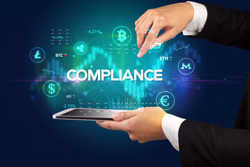 Close-up of a touchscreen with COMPLIANCE inscription, business opportunity concept