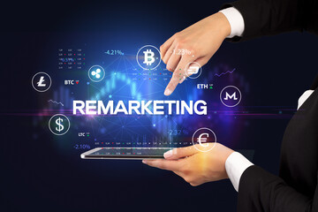 Close-up of a touchscreen with REMARKETING inscription, business opportunity concept