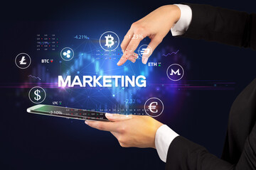 Close-up of a touchscreen with MARKETING inscription, business opportunity concept