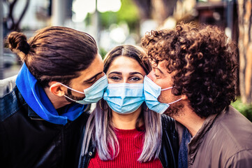 Double kiss with medical protective mask on face for fear of virus infection - Young millennials...
