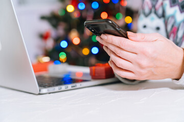 Christmas online shopping. Woman buy presents, prepare to xmas, among shopping cart and presents box. Winter holidays Merry Xmas winter holidays sales concept. Selective focus.