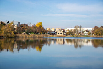 Fototapeta premium Photo of a n autumn landscape with a lake and cozy nordic houses in Vilnius